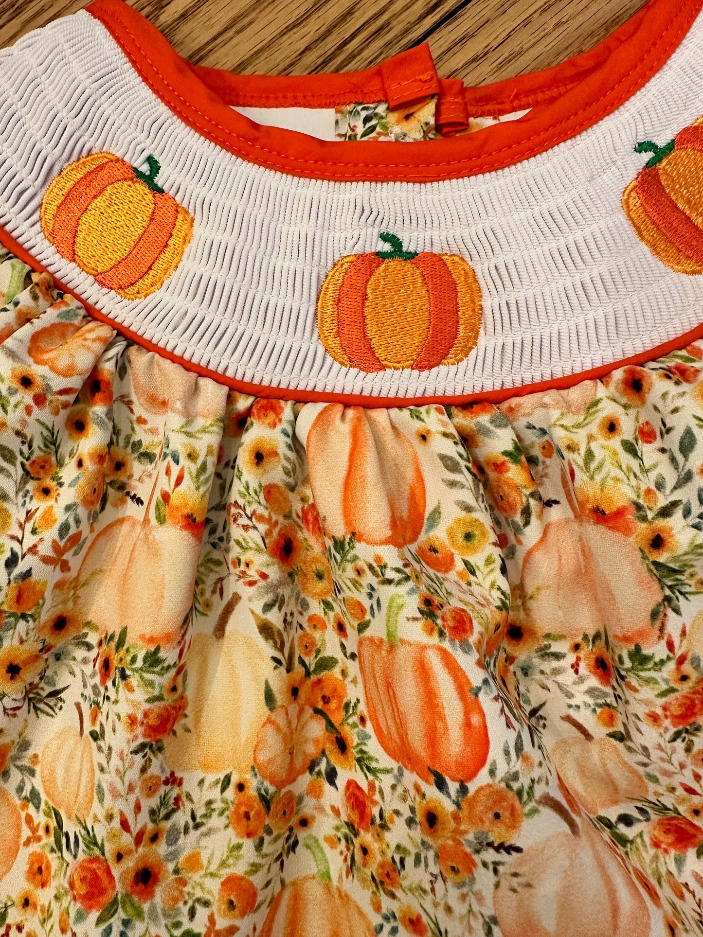 Adorable Baby Girl and Toddler Girls Smocked Pumpkin Fall Dress Adorned with Pumpkin Smocked Bodice.